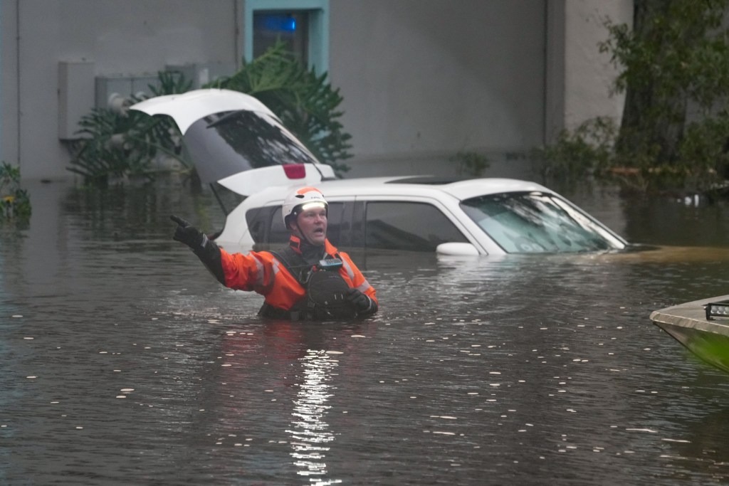 First responders in the water outside an apartment complex that was flooded from an overflowing creek in Clearwater.
