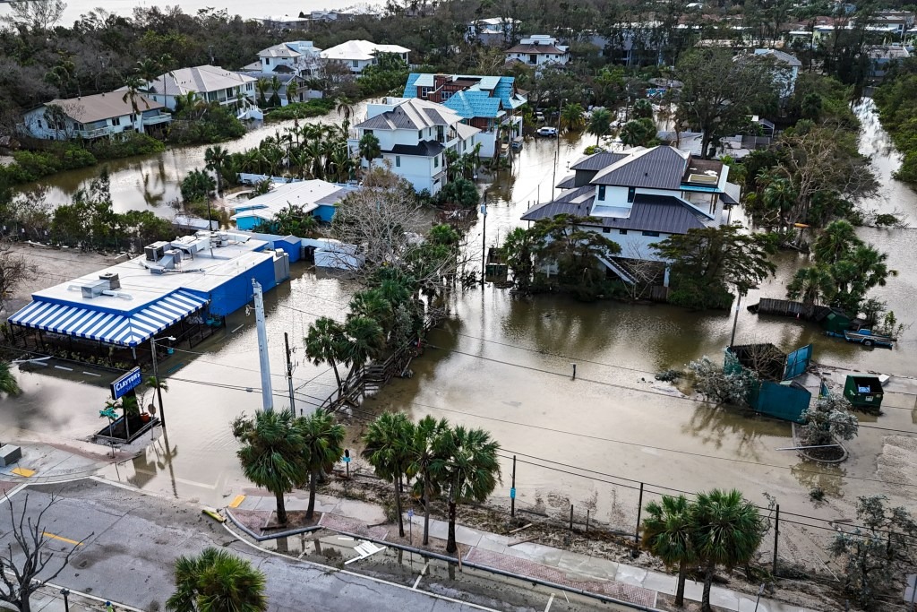 Drone view of a flooded street in Siesta Key, Florida.
