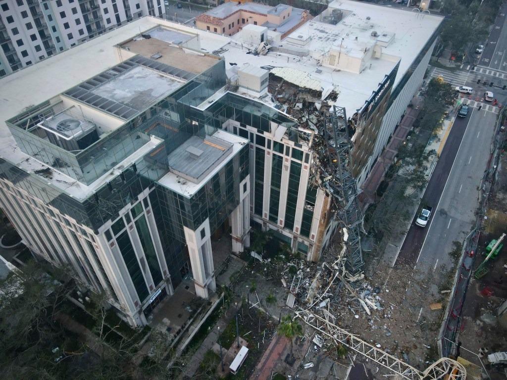 A collapsed construction crane that fell on the building that also hosts the offices of the Tampa Bay Times, after Hurricane Milton made landfall, in downtown St. Petersburg, Florida, U.S. October 10, 2024.
