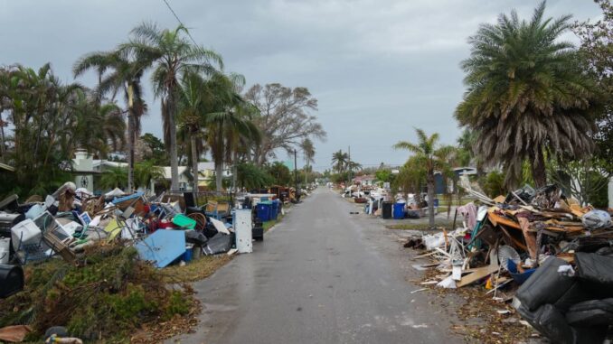 Debris from Hurricane Helene lines a street in the Redington Beach section of St. Petersburg, Florida ahead of Hurricane Milton’s expected landfall.