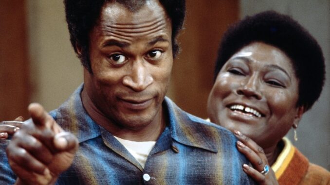 John Amos, left, with co-star Esther Rolle in an episode of the CBS sitcom “Good Times.” The show premiered in 1974 and aired for six seasons. (CBS via Getty Images)