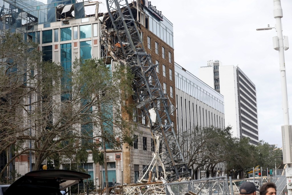 A collapsed construction crane that fell on the building that also hosts the offices of the Tampa Bay Times, after Hurricane Milton made landfall, in downtown St. Petersburg, Florida, U.S. October 10, 2024.
